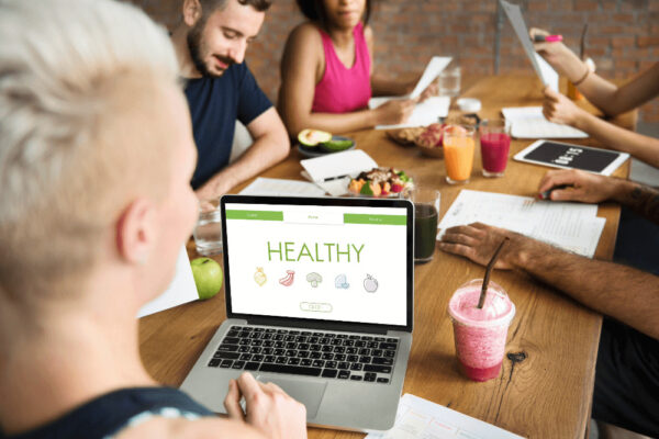 health social media marketing represented by people sitting at a table with smoothies in a marketing meeting